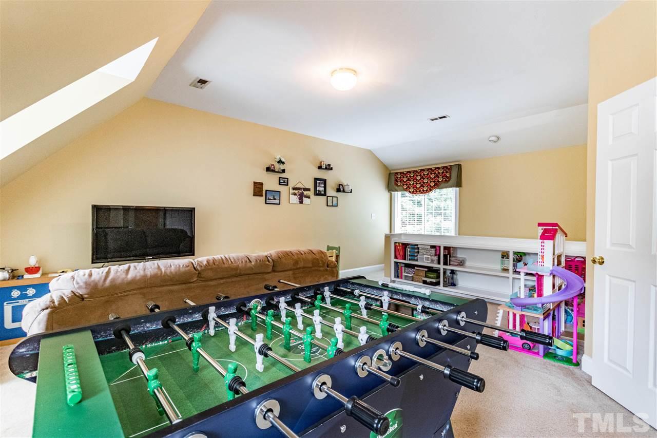 8108 Fallston Court Raleigh, NC 27613 - Photo 21 of 23 a bedroom with furniture and a flat screen tv