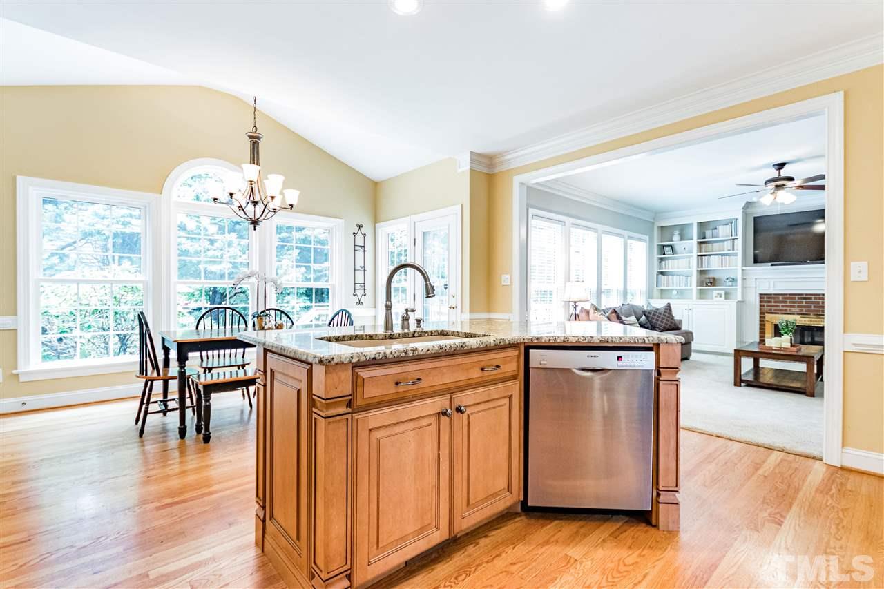 8108 Fallston Court Raleigh, NC 27613 - Photo 5 of 23 a kitchen with a table chairs stove and cabinets