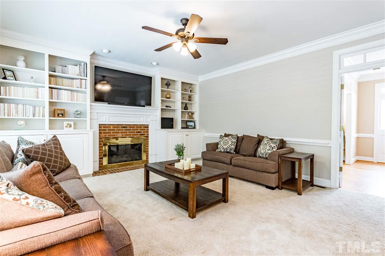 8108 Fallston Court Raleigh, NC 27613 - Photo 10 of 23 a living room with furniture fireplace and flat screen tv