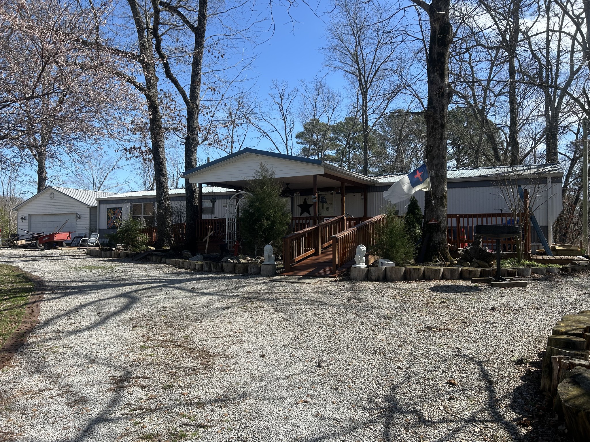 160 Wilson Cemetery Road Big Sandy, TN 38221 - Photo 3 of 20 a view of a house with a yard covered with snow and trees