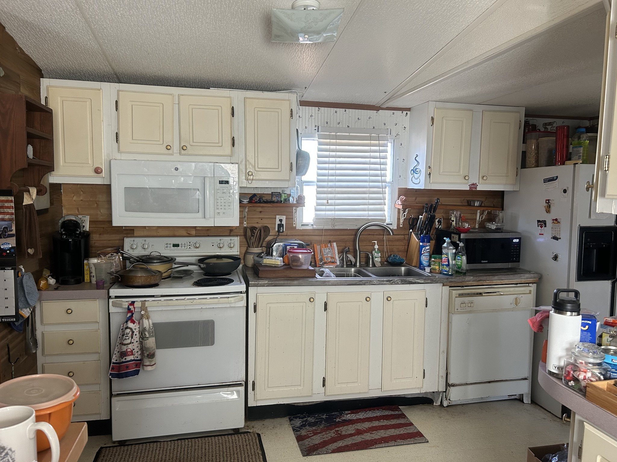 160 Wilson Cemetery Road Big Sandy, TN 38221 - Photo 7 of 20 a kitchen with white cabinets and white appliances