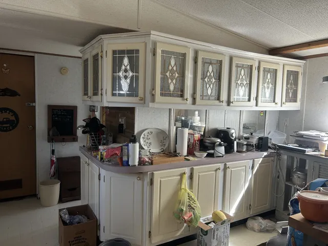 a kitchen with a sink appliances and cabinets