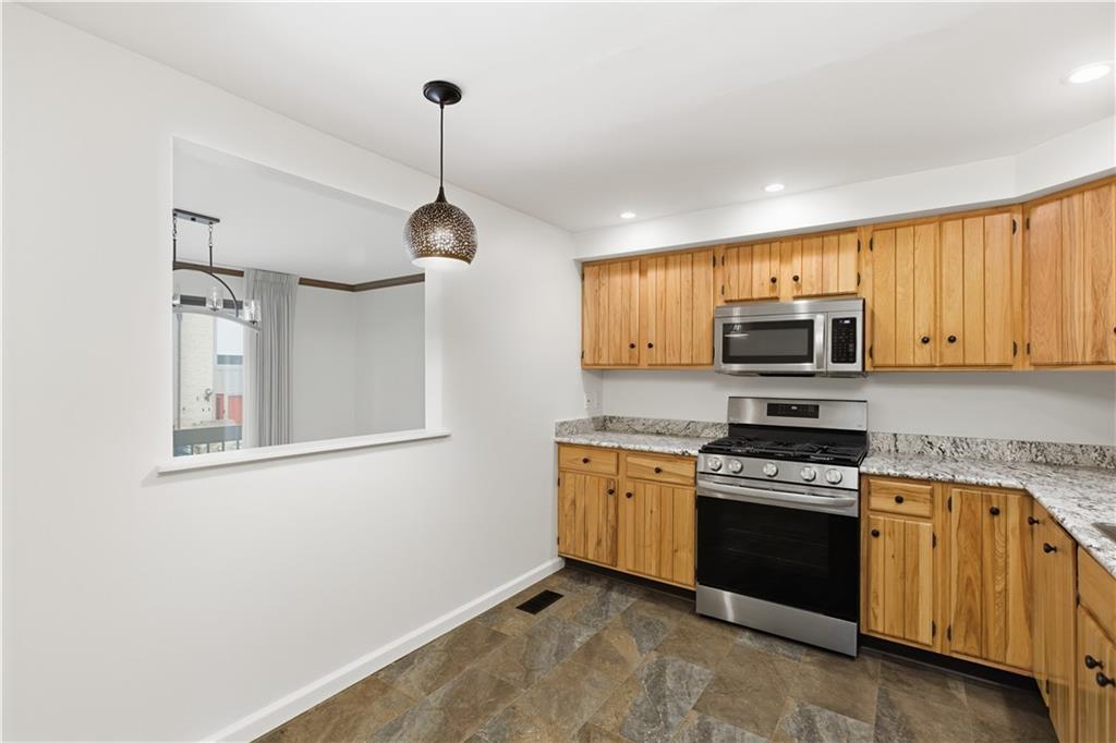 146 Locust Court Pittsburgh, PA 15237 - Photo 8 of 32 a kitchen with stainless steel appliances granite countertop a sink a stove a refrigerator cabinets and a window