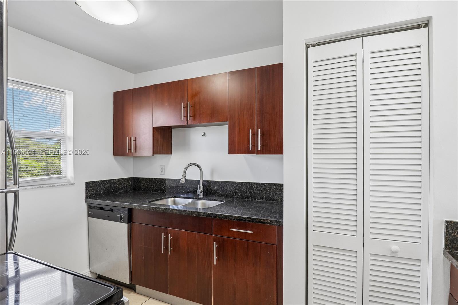 4137 Stirling Road, Unit 507 Dania Beach, FL 33314 - Photo 7 of 20 a kitchen with a sink and cabinets