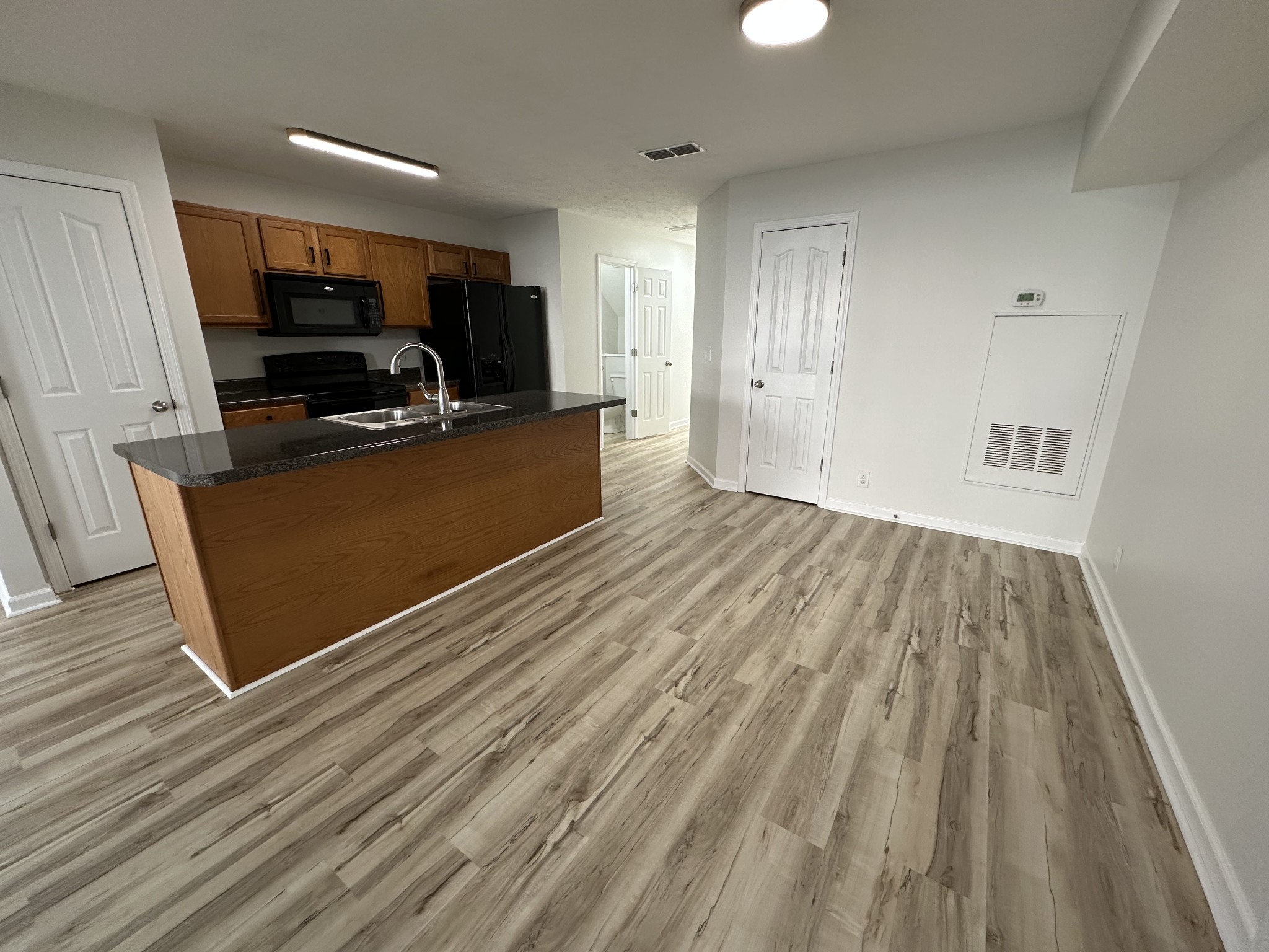 202 Latimer Drive Smyrna, TN 37167 - Photo 3 of 30 a view of kitchen with microwave a stove and wooden floor