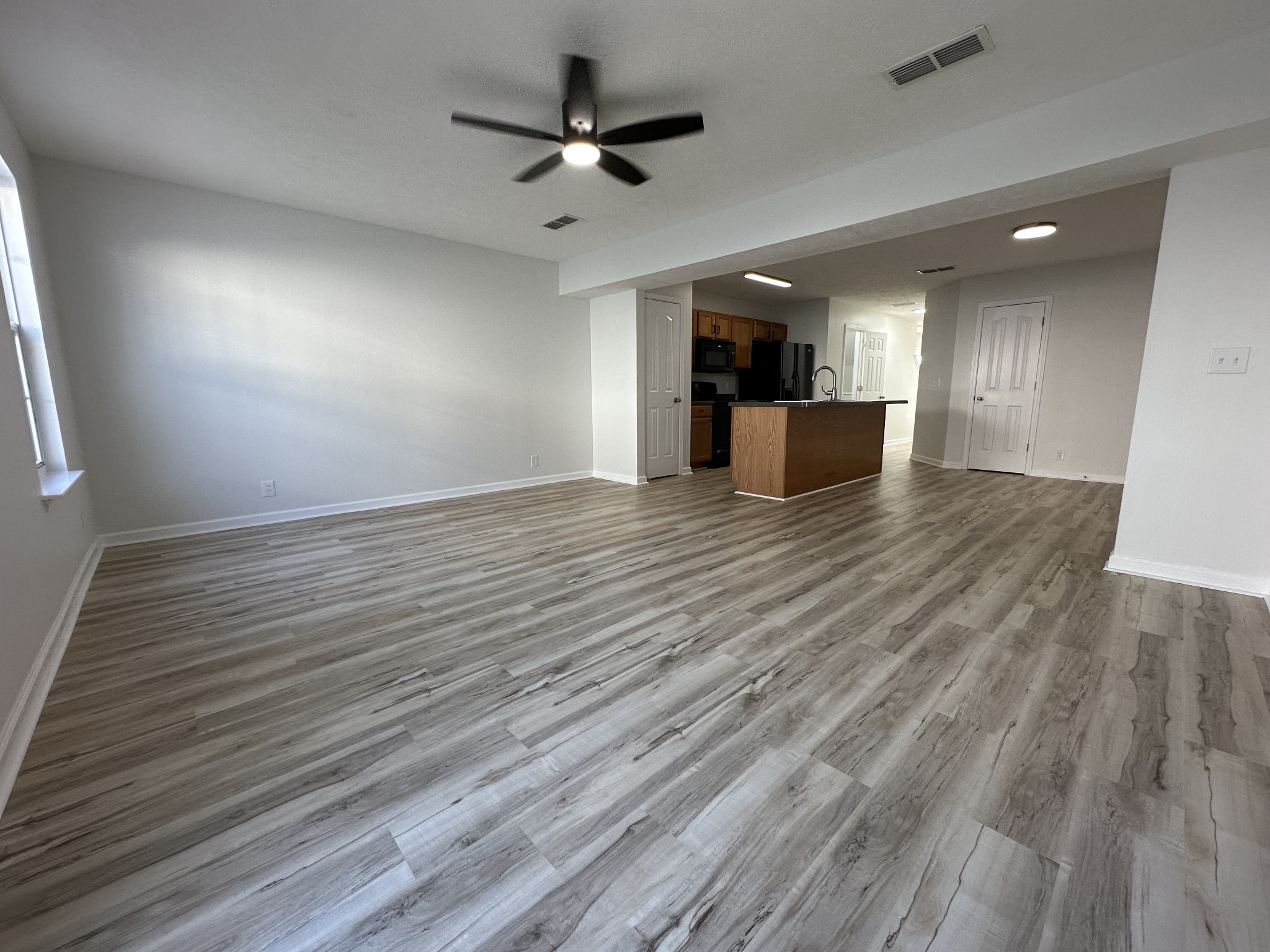 202 Latimer Drive Smyrna, TN 37167 - Photo 5 of 30 an empty room with wooden floor and a ceiling fan