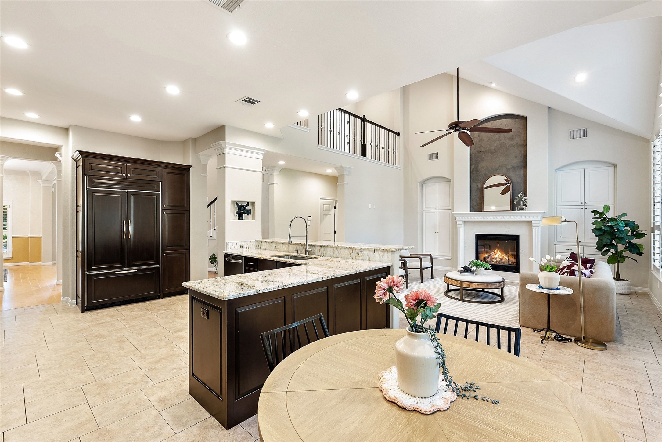 8215 Dark Ridge Cove Austin, TX 78737 - Photo 14 of 40 An open concept design seamlessly blends the kitchen, living room, and a captivating fireplace.