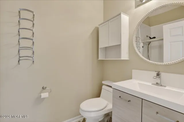 a bathroom with a toilet a sink and mirror