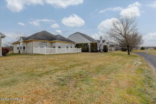 a view of a house with a yard and garage