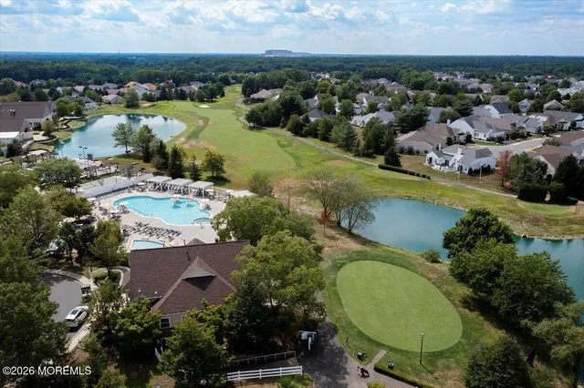 an aerial view of a residential houses with outdoor space and swimming pool
