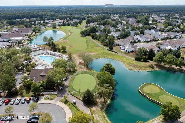 an aerial view of a house with a swimming pool yard and outdoor seating