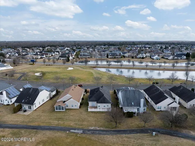 a view of a swimming pool with lawn chairs