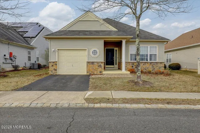 a view of a house with a yard and garage