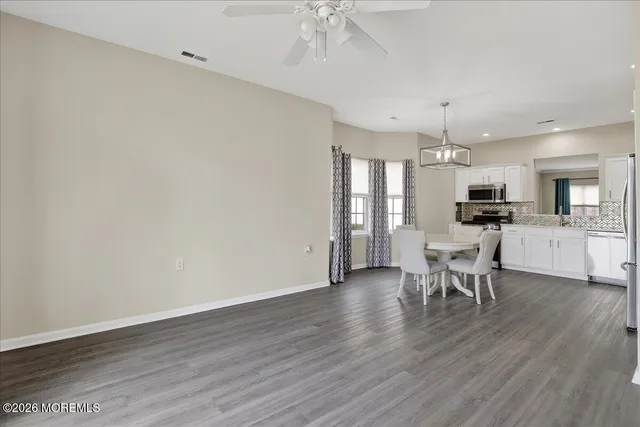 a view of a dining room with furniture and wooden floor