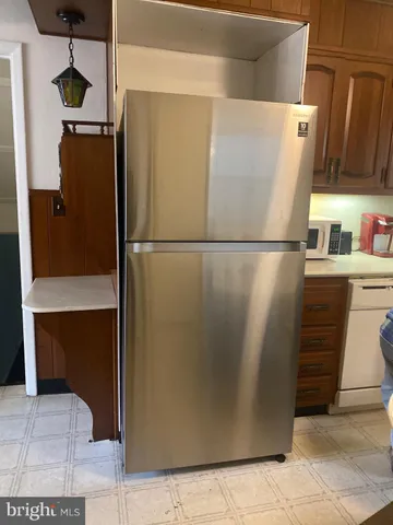 a white refrigerator freezer sitting in a kitchen
