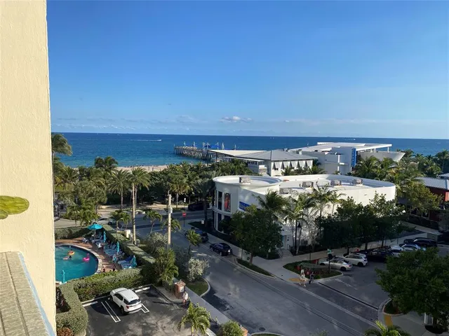 a kitchen with white cabinets and sink