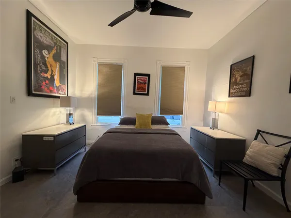 a bedroom with a bed and a desk