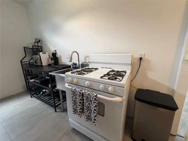 a white stove top oven sitting inside of a kitchen