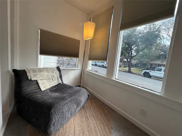 a bedroom with a bed and large mirror