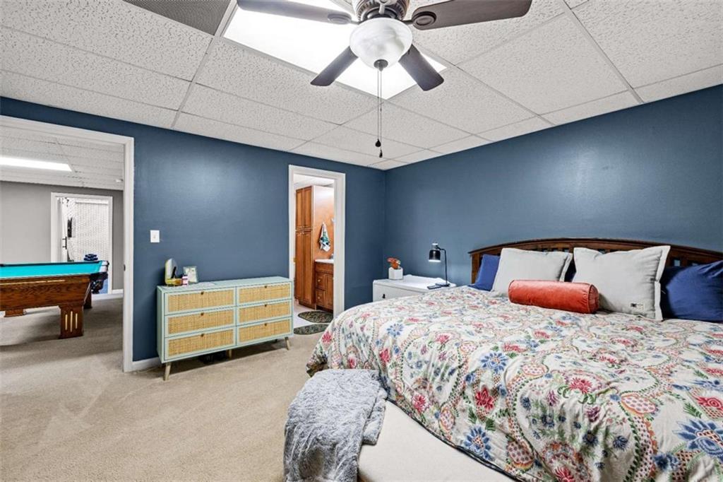 128 Byrom Road Senoia, GA 30276 - Photo 53 of 83 a bedroom with a bed and a chandelier