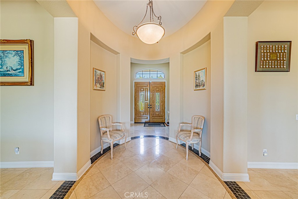 4088 Shady Ridge Circle Corona, CA 92881 - Photo 5 of 47 a view of a hallway with wooden floor and a bathroom
