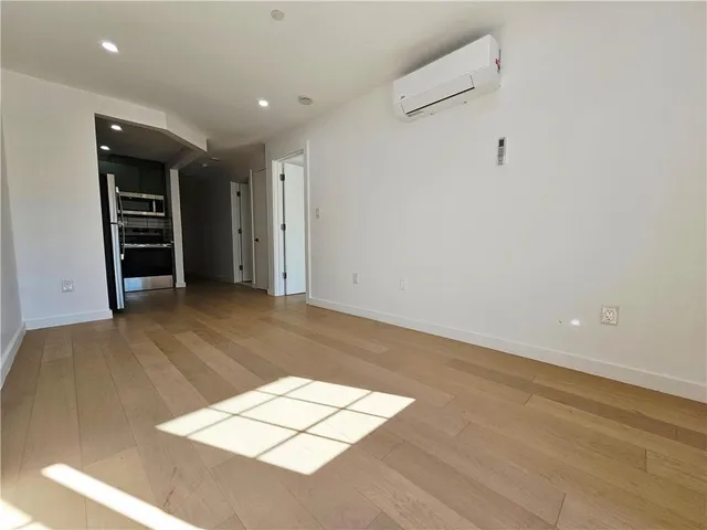an empty room with closet and windows