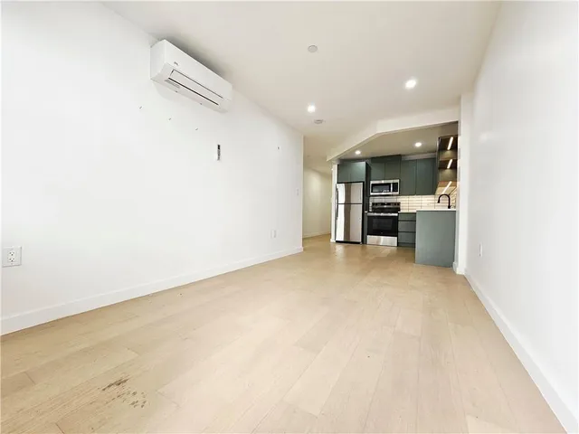 a view of a kitchen with a sink and a refrigerator