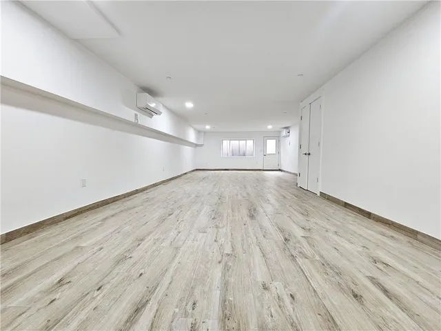 a view of an empty room and wooden floor