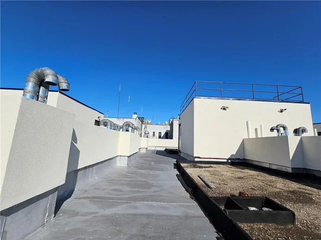 a view of a kitchen with a fridge and wooden floor