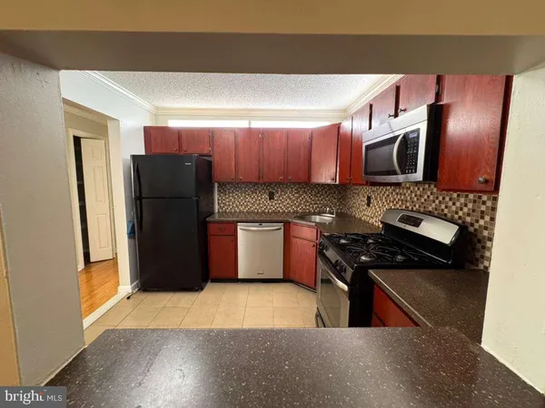a kitchen with a refrigerator and a stove