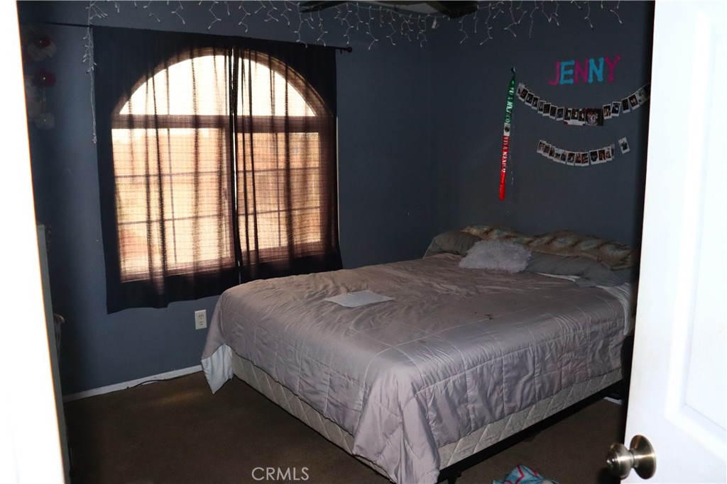 5642 Lighthouse Lane Palmdale, CA 93552 - Photo 12 of 24 a bedroom with a bed and a large window
