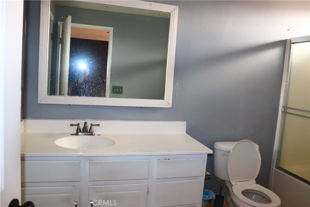 5642 Lighthouse Lane Palmdale, CA 93552 - Photo 17 of 24 a bathroom with a sink toilet and mirror