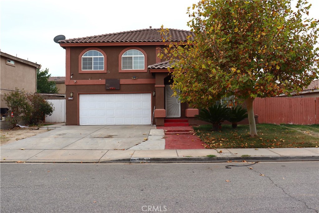 5642 Lighthouse Lane Palmdale, CA 93552 - Photo 2 of 24 a front view of a house with a yard and garage