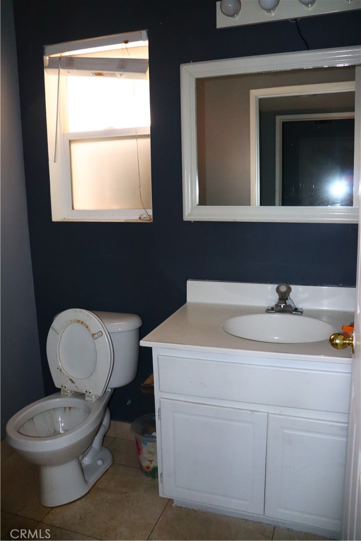 5642 Lighthouse Lane Palmdale, CA 93552 - Photo 10 of 24 a bathroom with a toilet sink and mirror