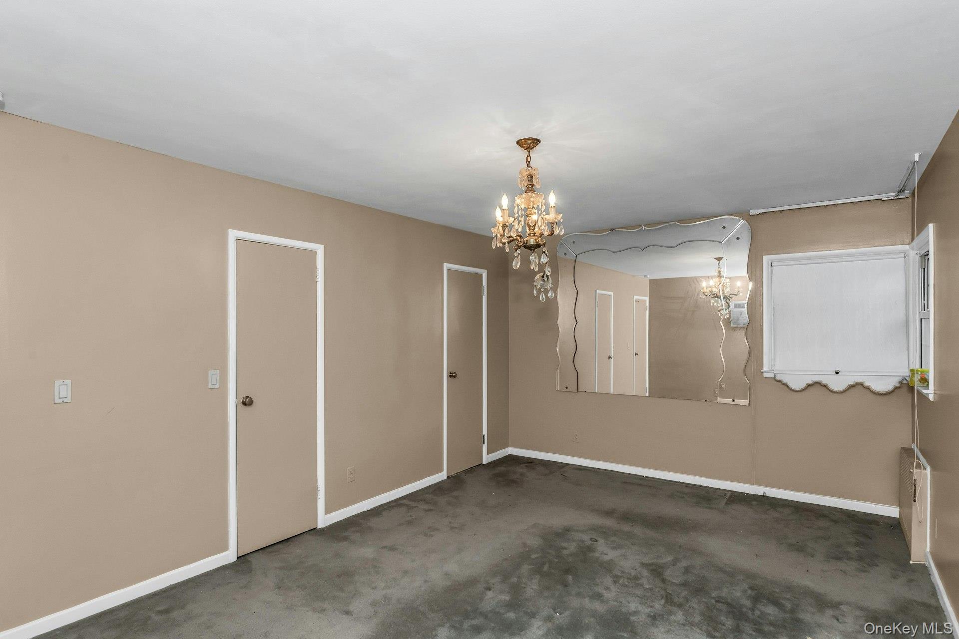 477 Demott Avenue Baldwin, NY 11510 - Photo 18 of 27 a view of a chandelier in big room and a bathroom