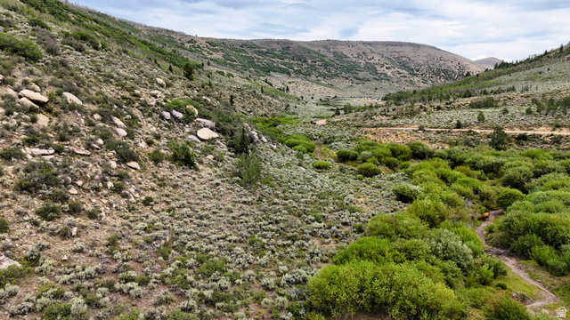 123 Beaver Creek Road Helper, UT 84526 - Photo 37 of 47 Expansive natural landscape featuring rolling hills, varied vegetation, and a winding dirt path