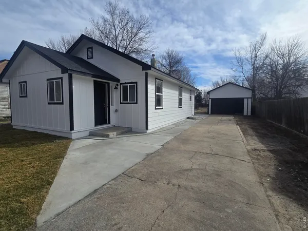 a view of a house with a yard and garage