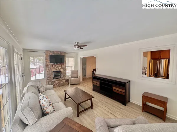 a living room with furniture a fireplace and a window