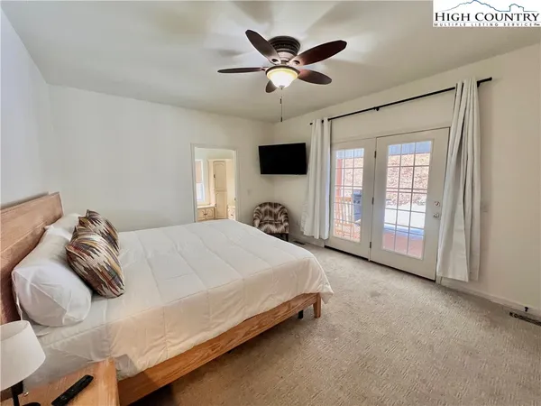 a bedroom with a large bed and a tv