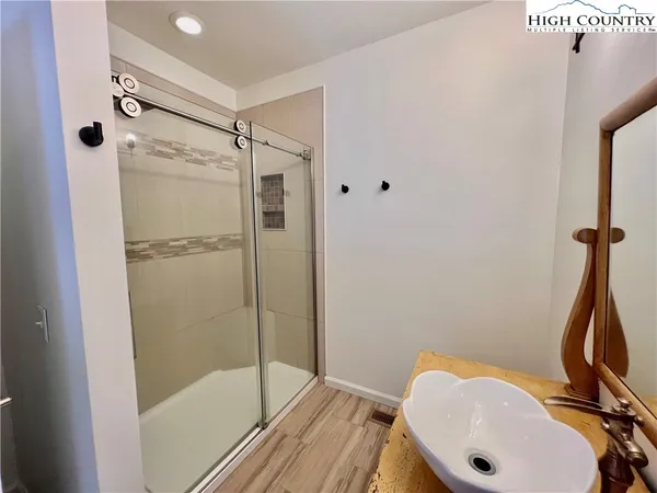 a bathroom with a shower and a sink
