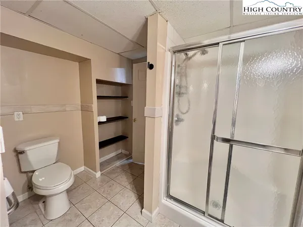 a bathroom with a toilet and a shower