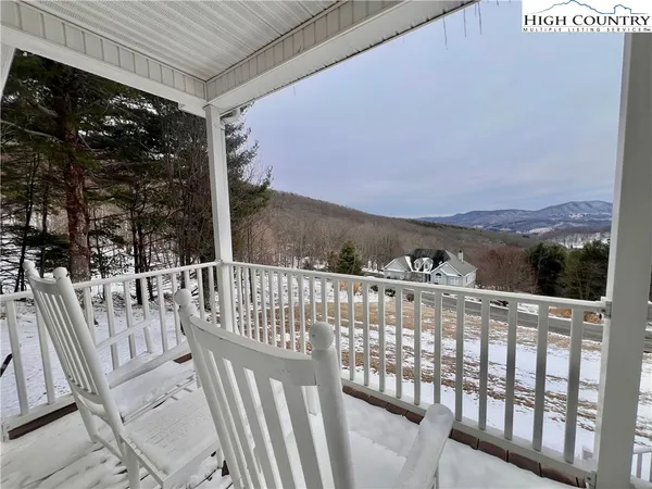 a view of a chair and tables in the balcony
