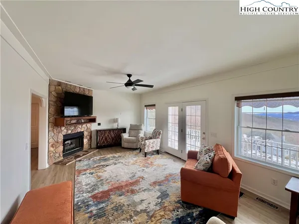 a living room with furniture flat screen tv and a fireplace
