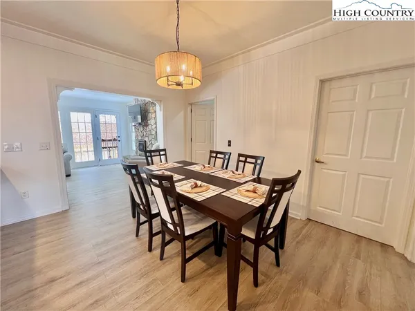 a view of a dining room with furniture wooden floor and chandelier