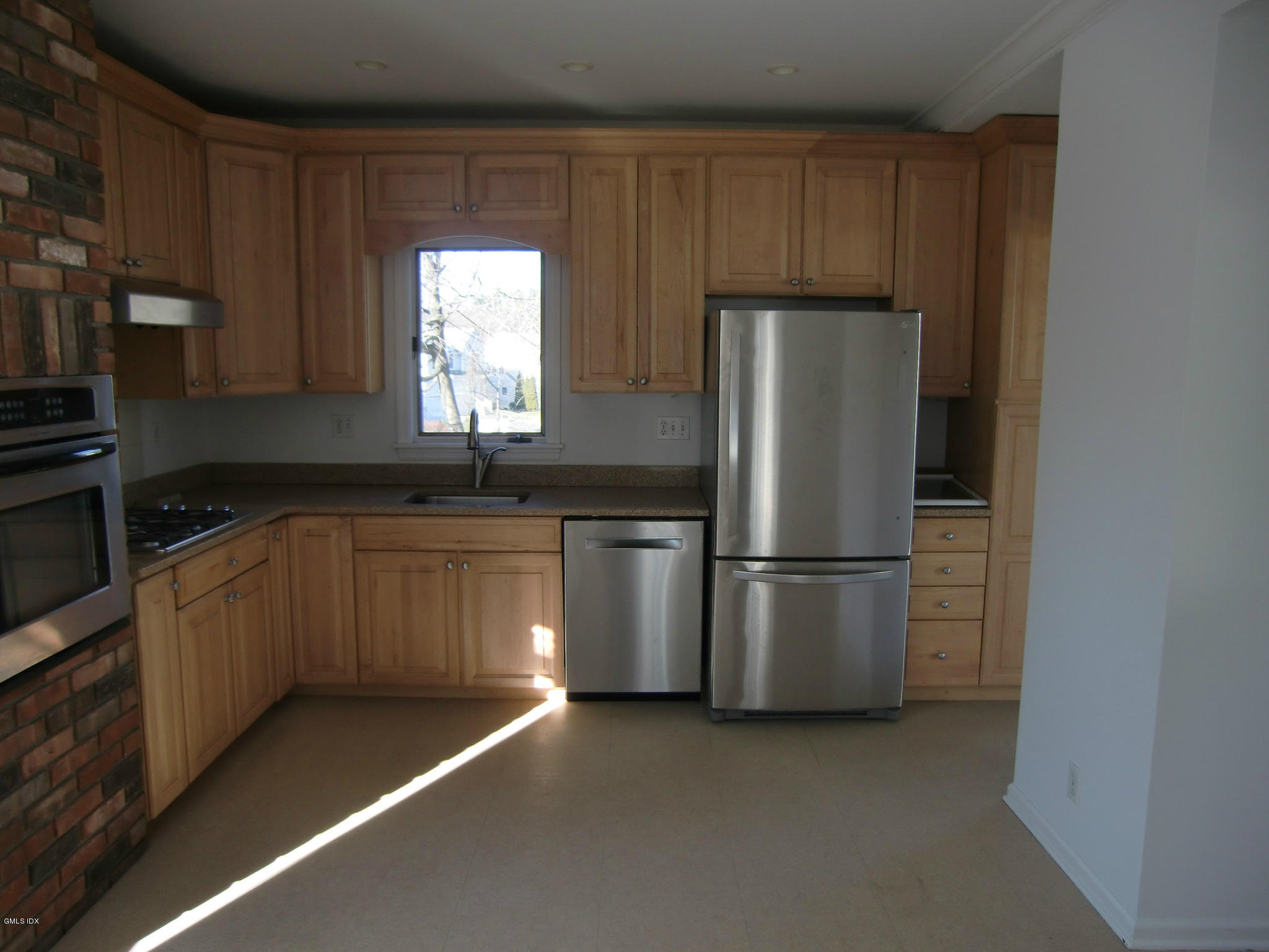 42 Harold Street Cos Cob, CT 06807 - Photo 5 of 10 a kitchen with a refrigerator sink and cabinets