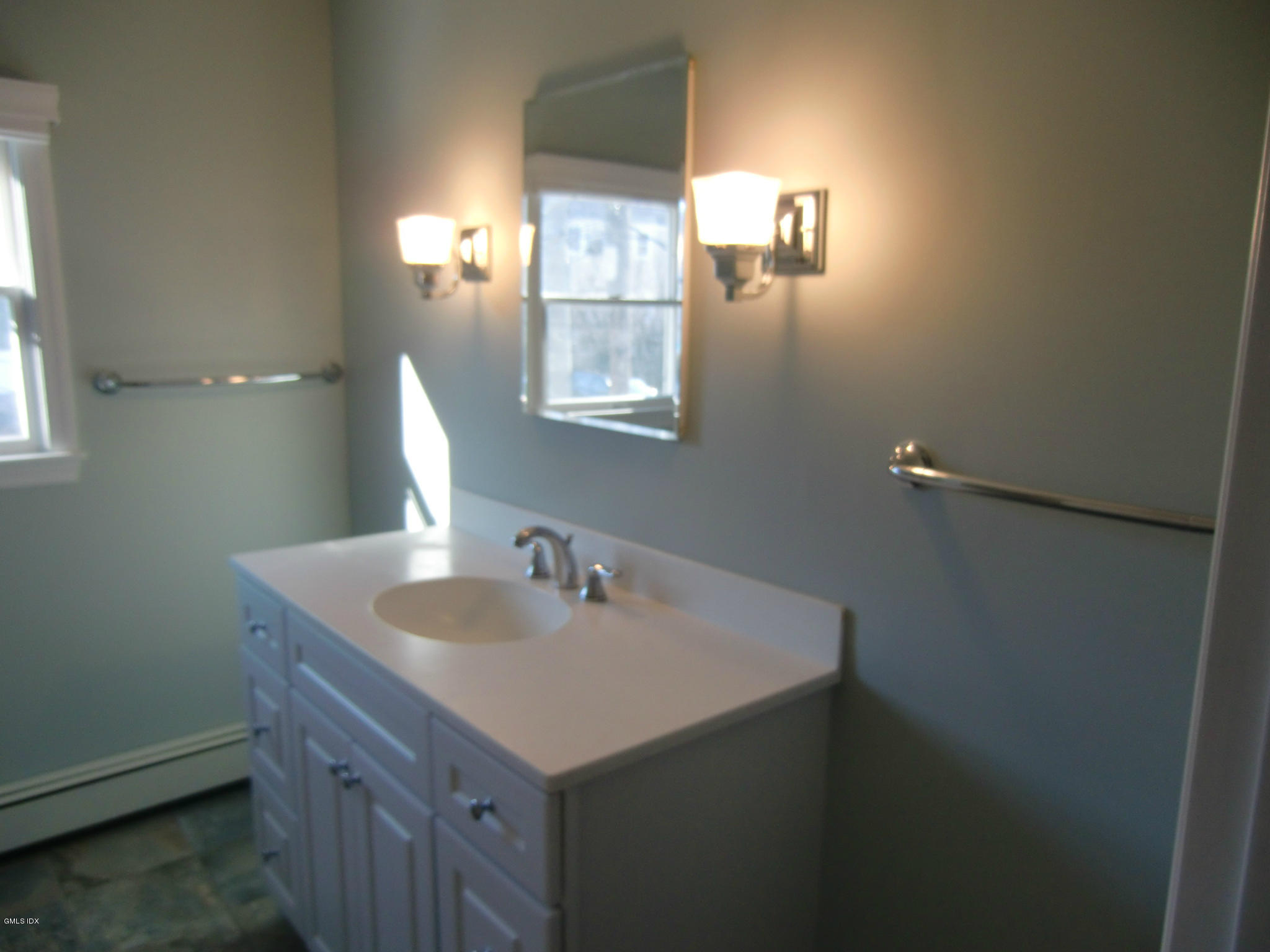 42 Harold Street Cos Cob, CT 06807 - Photo 8 of 10 a bathroom with a sink and a mirror