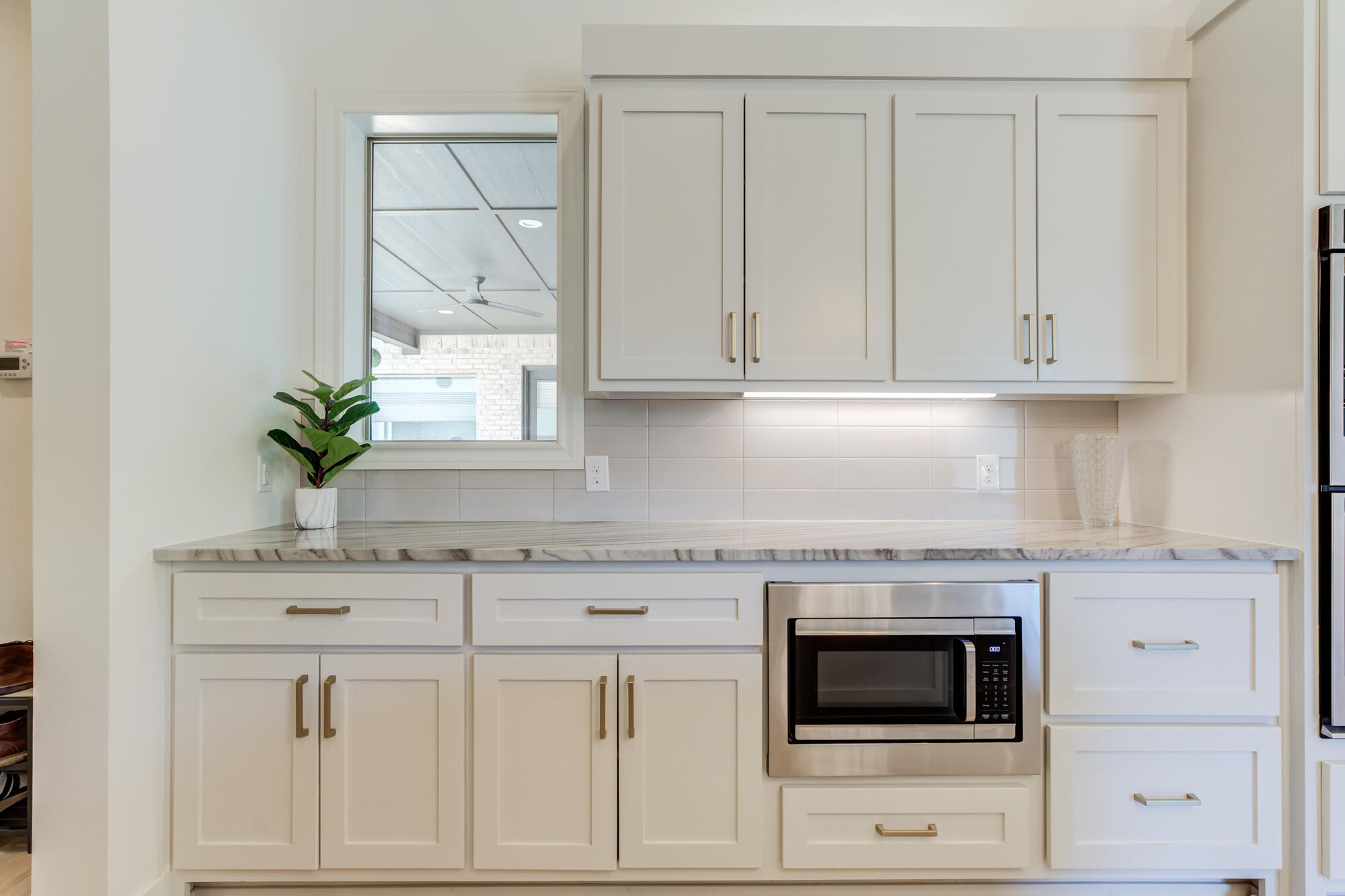 4813 5th Street Lubbock, TX 79416 - Photo 25 of 62 a kitchen with white cabinets and white appliances