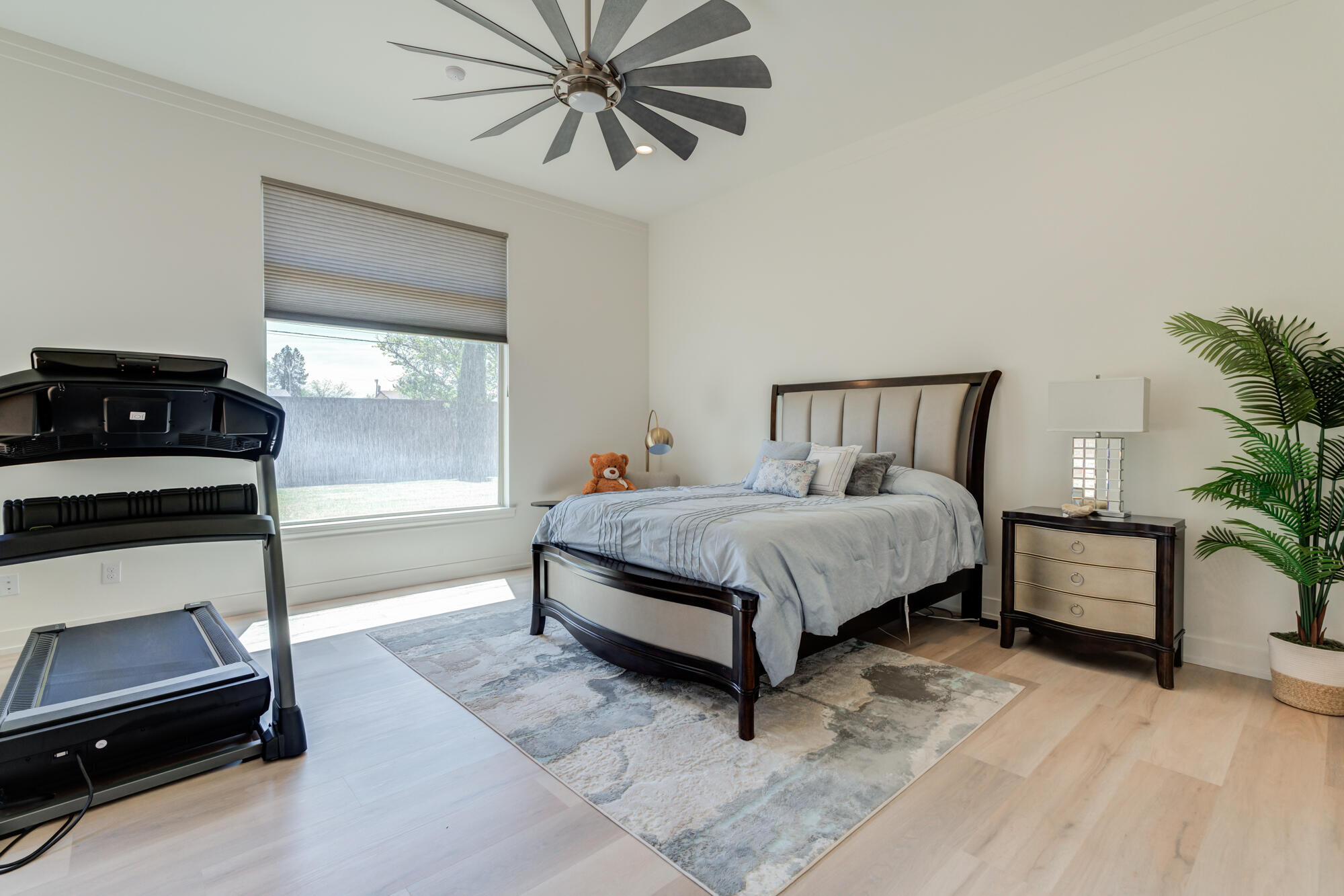 4813 5th Street Lubbock, TX 79416 - Photo 28 of 62 a bedroom with a bed and a potted plant on the dresser