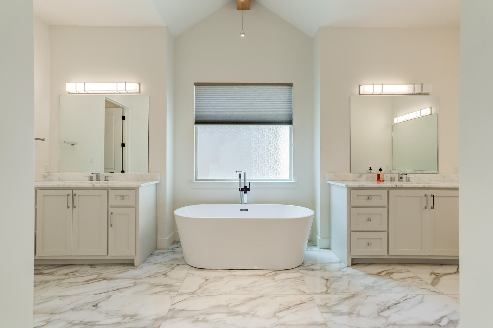 4813 5th Street Lubbock, TX 79416 - Photo 30 of 62 a spacious bathroom with a double vanity sink mirror and bathtub