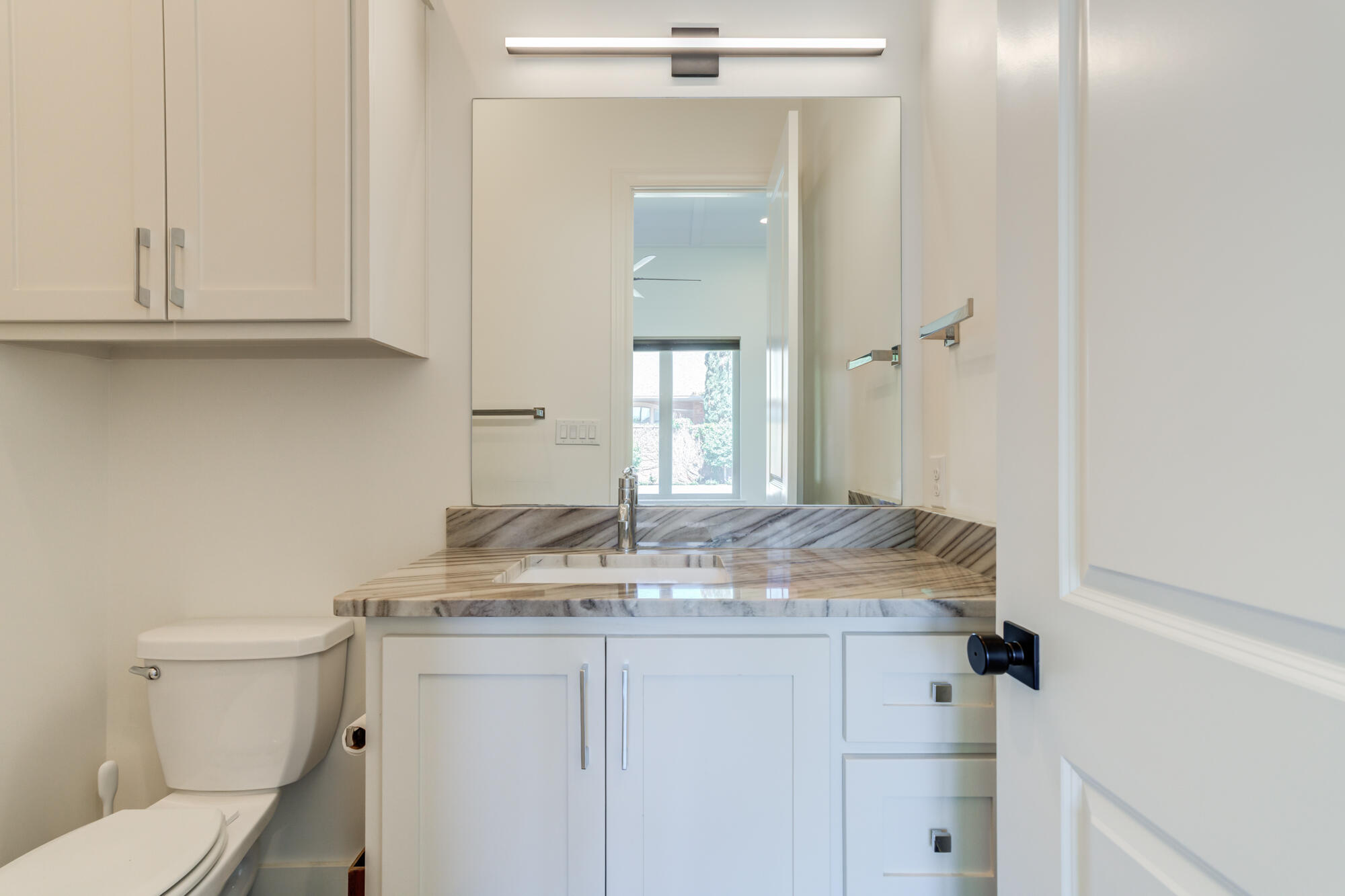 4813 5th Street Lubbock, TX 79416 - Photo 39 of 62 a bathroom with a granite countertop sink and a mirror